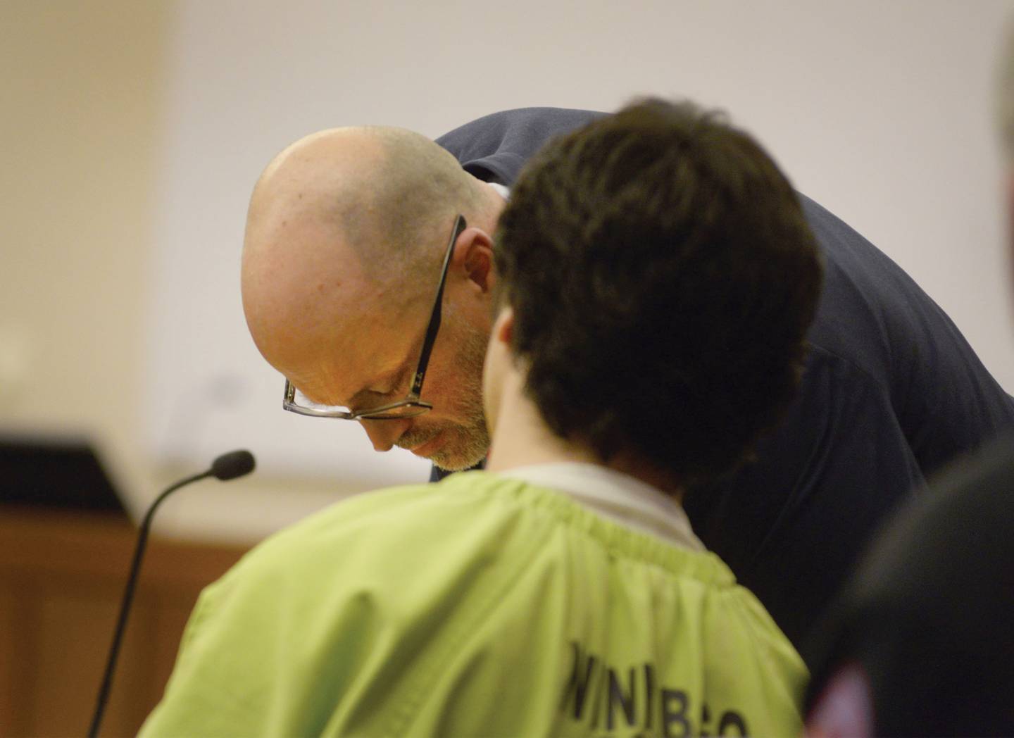 Jonathon Gounaris, seated, talks to his attorney, Assistant Public Defender Michael O'Brien, during a Monday, April 7, 2025, hearing at the Ogle County Judicial Center in Oregon. Gounaris is charged with shooting three police officers during a June 2024 incident at his home in rural Dixon. He is being held at the Winnebago County Jail as his attempted murder case proceeds through the court system.