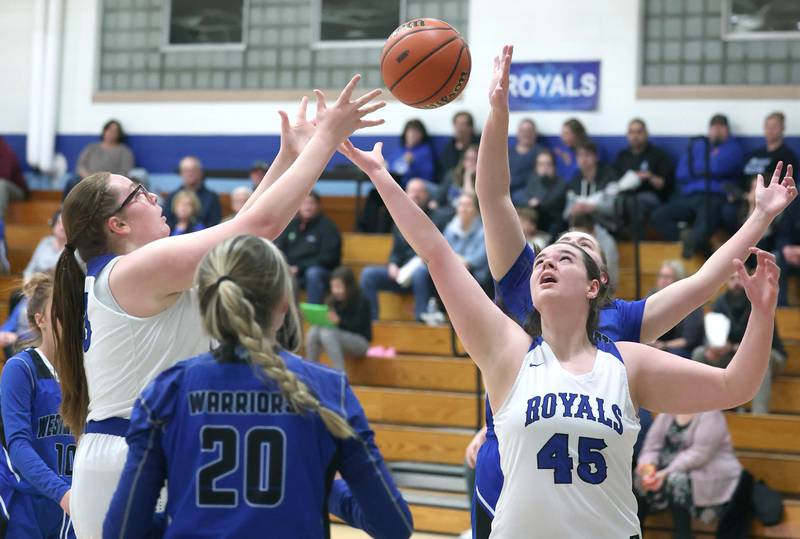 Hinckley-Big Rock's Sami Carlino (left) and Devin Werner try to grab a rebound in front of Westminster Christian's Emma Faidley during their regional semifinal game Monday, Feb. 13, 2023, at Hinckley-Big Rock High School.