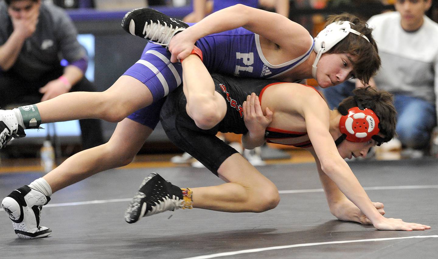 Plano's Mauricio Romero takes down Mooseheart's Tilar Murphy in a 106-pound bout during the Class 1A Wrestling Regional at Plano High School on Saturday, Feb. 4, 2023.