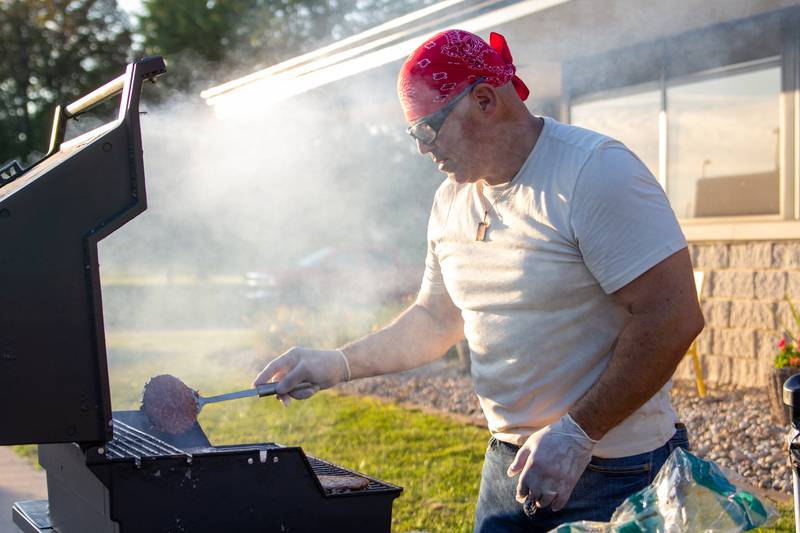 Rutilio Arteaga flips burgers on the grill Friday, Aug. 23, 2024, at Family Safe Night at the Mendota Civic Center.