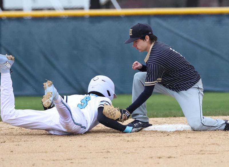 Parkview Christian Academy's Alex Donelson dives back to second safely as Hiawatha's Aaron Jindrich applies the tag Thursday, April 17, 2025, during their game at Hiawatha High School in Kirkland.