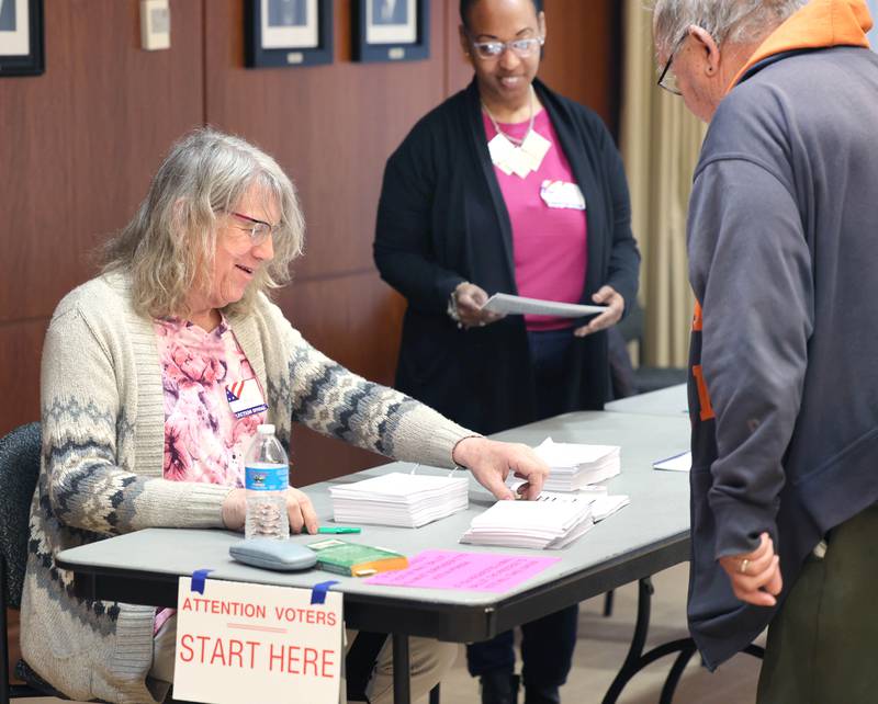 Election judge Rose O’Halloran checks in a voter on Election Day Tuesday, April 4, 2023, at the polling place in Barsema Alumni and Visitors Center at Northern Illinois University in DeKalb.