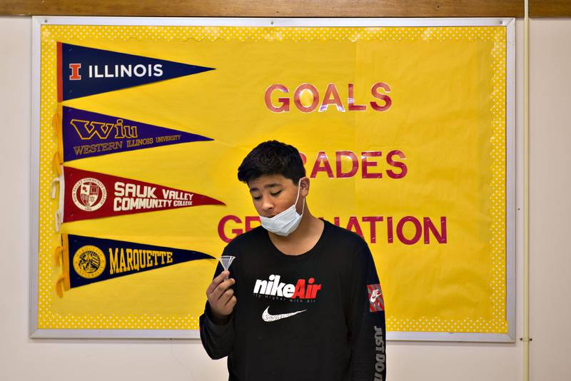Sterling High School freshman Jonavn Jimenez prepares to supply a saliva sample Friday morning during COVID-19 contact tracing. Every morning, students who have come in close contact with a person who has tested positive must take a SHIELD Illinois test.