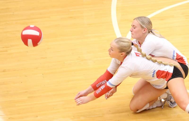 Ottawa's Ella Damron and teammate Ana Zeglis dive for the ball at the same time against L-P on Thursday, Oct. 17, 2024 in Kingman Gym at Ottawa High School.