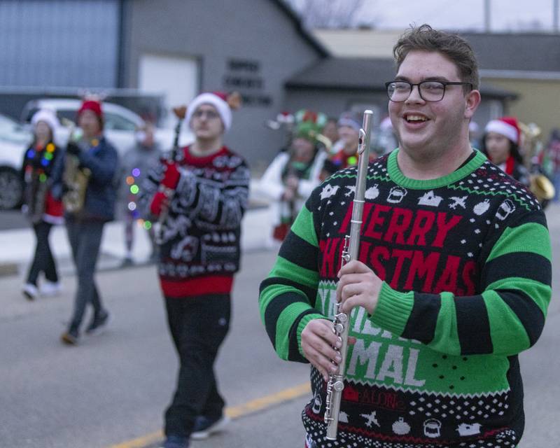 LaSalle Peru High School band member Carl Hicks marches with his flute during the Oglesby Winter Parade on December 9, 2023.