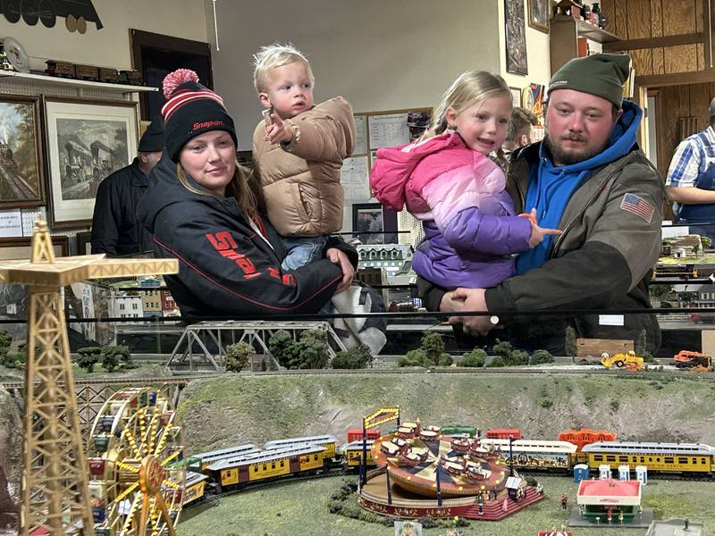 The Ukena family of Polo look over one of the Blackhawk Model Railroad Club's train set displays Saturday, Nov. 30, 2024, in Conover Square during Oregon's Candlelight Walk. Pictured are Liz and Bailey Ukena with their children, Memphis 2, and Elanor, 4. The club, located on the second floor of Conover Square, 201 N. Third St., Oregon, is open every weekend, 10 a.m. to 4 p.m. Saturdays and 1 to 4 p.m. Sundays. Visitors of all ages are welcome to come see the trains free of charge. Donations are accepted. The club does not sell or buy model railroad equipment.