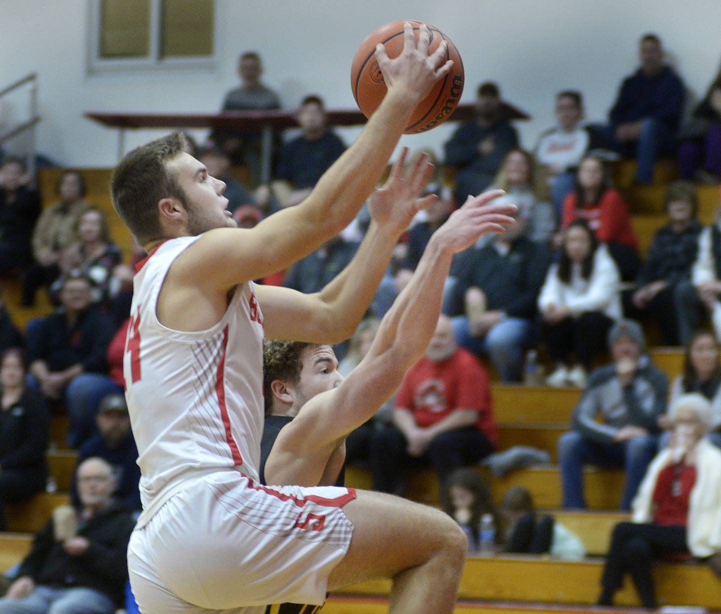 Streator’s Landon Muntz goes up and over Reed Custer’s Peyton Bradley to score in the 1st period Tuesday at Streator