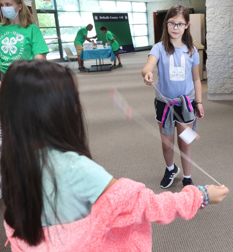 Aletta Sexton, (right) 9, from Lee, and Naya Collins, 9, from Sycamore try out their bee buzzer noise makers during the 4-H General Project Show Thursday, July 14, 2022, at the DeKalb County Farm Bureau in Sycamore.