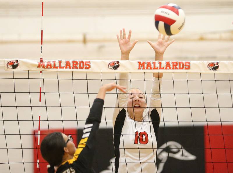Henry-Senachwine's Rachel Eckert blocks a spike with her fingertips from Putnam County's Addy Leatherman on Thursday, Aug. 28, 2025 at Henry-Senachwine High School.