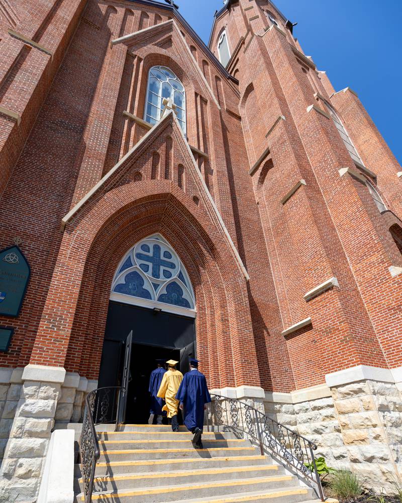 Class of 2026 Marquette Academy Graduates walk up stairs into St. Columba Church before the Graduation Ceremony on May 24, 2026 in Ottawa.