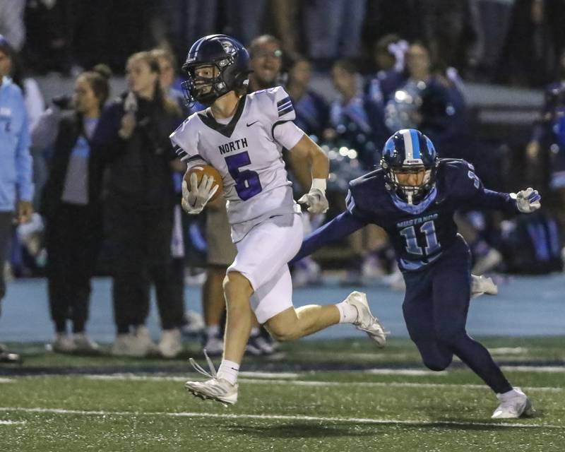 Downers Grove North's Maxwell Troha (5) runs back the opening kickoff during football game between Downers Grove North at Downers Grove South Friday, Sept 5, 2025  in Downers Grove.