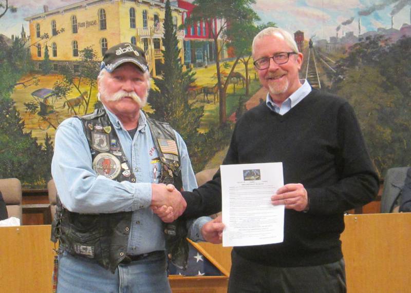 Cliff Oleson, Open Roads ABATE of IL, Inc. Chapter President, pictured left, receives the signed proclamation from Plano Mayor Mike Rennels.