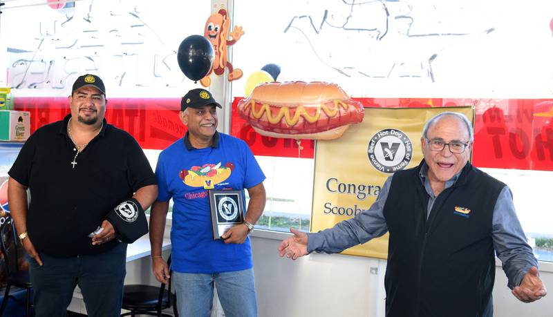 Vienna Beer Senior Vice President Bob Schwartz welcomes Scooby's Hot Dogs in Downers Grove and their manager by Miguel Escobedo, left, and owner Mihir Patel, into the Vienna Beef Hall of Fame. It's the 150th restaurant to be inducted since it's inception in 2006.