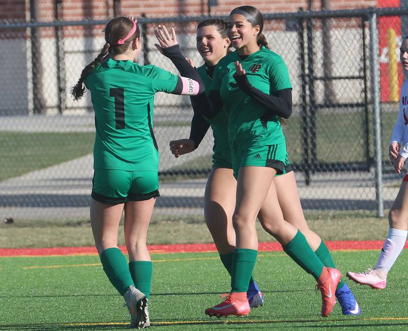 L-P's Addie Dawson hi-fives teammate Vizion Byrd and Payton Wren after Byrd scored a goal on Friday, March 27, 2026 at the L-P athletic complex in La Salle.