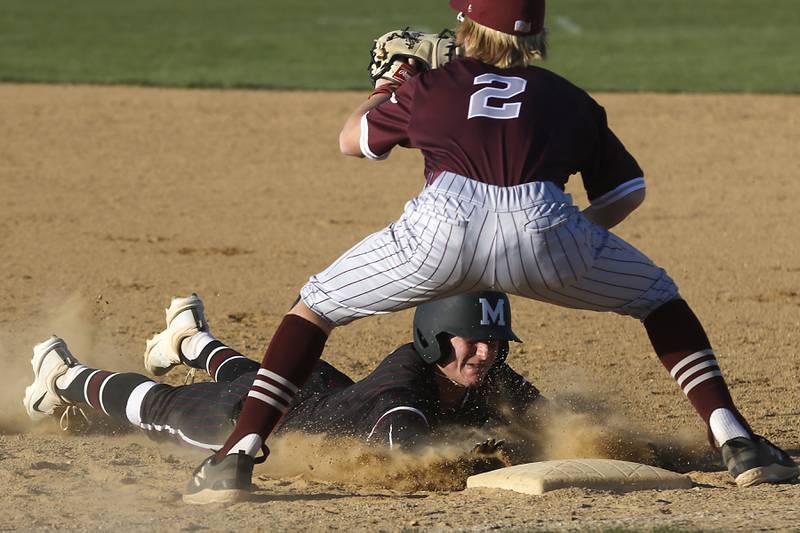 Marengo's Quinn Lechner dives back under the throw to Richmond-Burton first baseman Ray Hannemann during a Kishwaukee River Conference baseball game on Thursday, April 25, 2024, at Marengo High School.