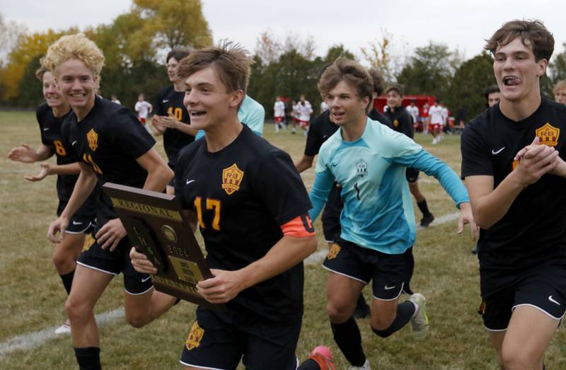 Richmond-Burton's Joseph Kyes and the rest of the ream run to their fans as they celebrate their 3-0 win over Marian Central in the IHSA Class 1A Marian Central Regional Boys Soccer Final match on Tuesday, Oct. 22, 2024, at Marian Central High School in Woodstock.