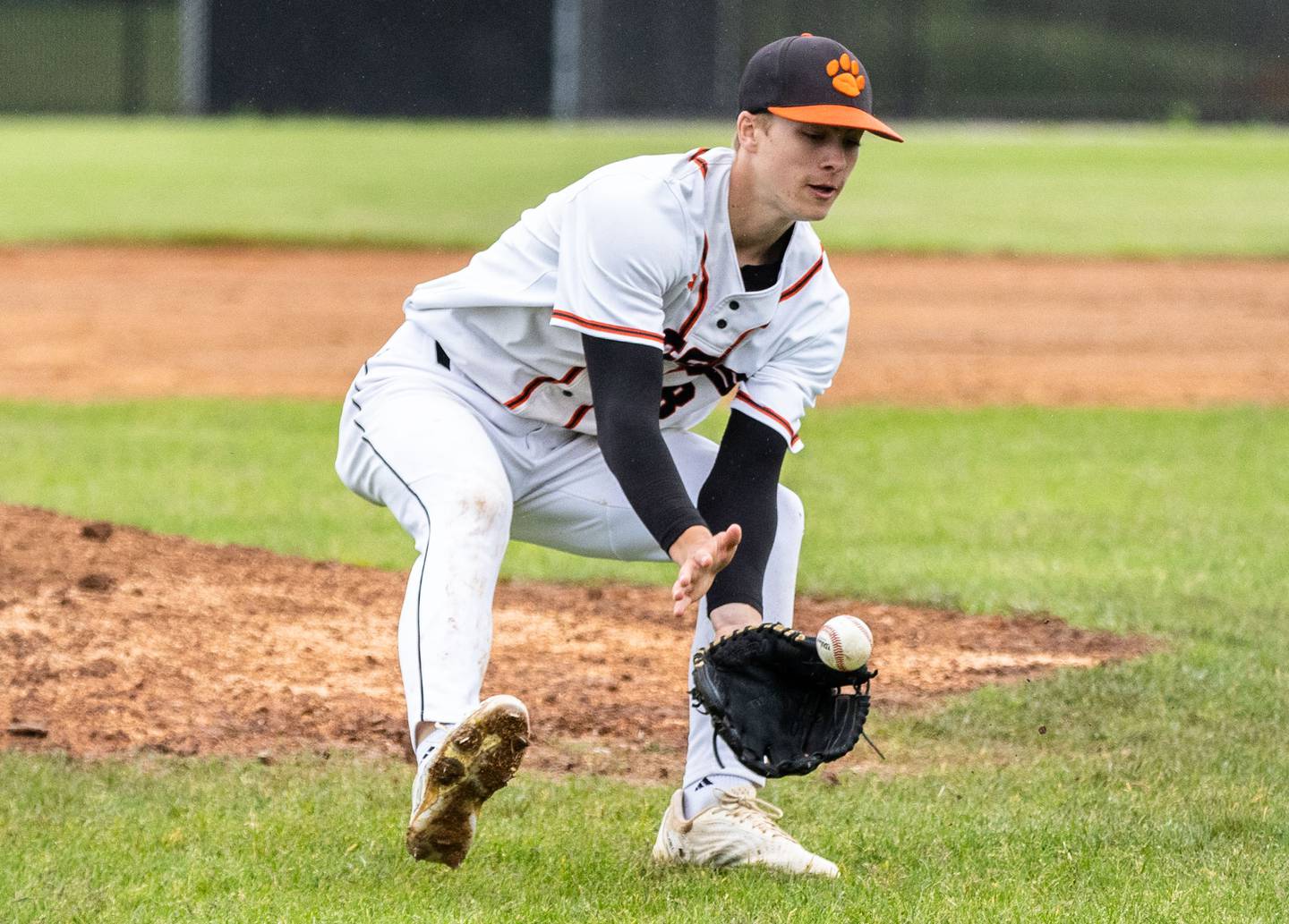 Wheaton Warrenville South pitcher Blake Snyder fields a ground ball during a game against St. Charles East in Wheaton on Wednesday, May 21, 2025.