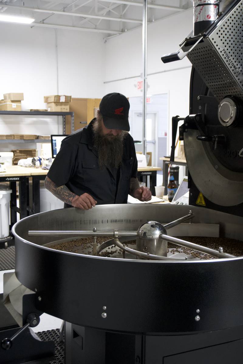 Dennis Jackson of Conscious Cup looks over the coffee roaster at the new facility in downtown Crystal Lake.