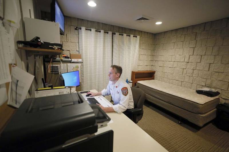Hanover Park Fire Department Lt. Scott Edwards works in office and living quarters that he shares with two other lieutenants when they are on duty at the village's aged station No. 2, which is set to be replaced next year using millions of dollars from the village's reserve fund. (Brian Hill-The Daily Herald)
