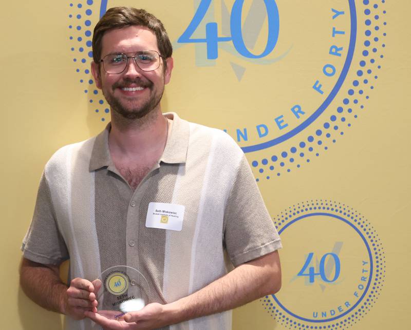 Seth Miskowiec poses with his 40 Under Forty award during the Illinois Valley Chamber of Commerce Champions of Change Awards Night on Wednesday, May 6, 2026 at the Westclox Event Center in Peru.