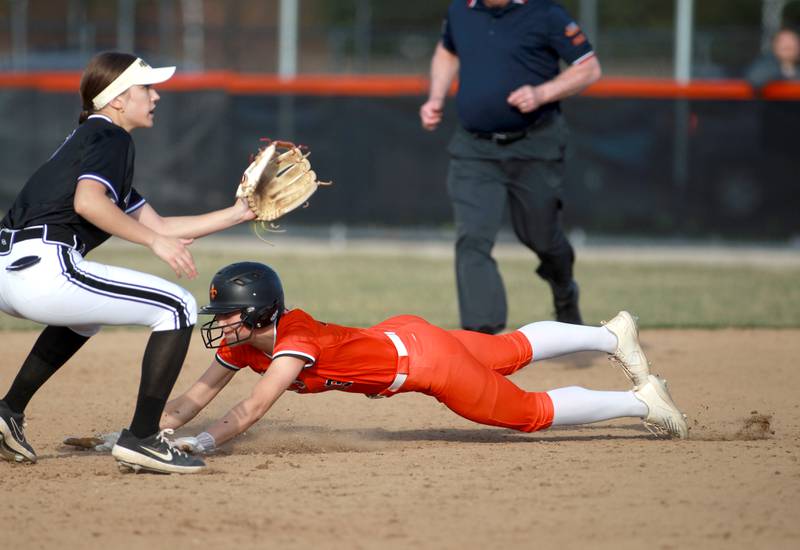 St. Charles East's Alyse Price slides safely into second under Downers Grove North's Viktoria Czech during a game on Friday, March 28, 2025 in St. Charles.