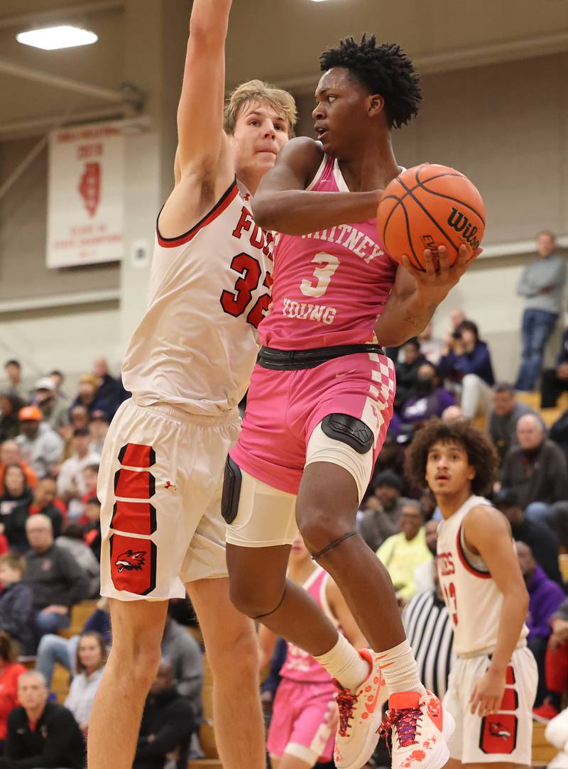 Yorkville’s Jason Jakstys (32) goes for the block against Whitney Young’s Marquis Clark (3) during the When Sides Collide Shootout on Saturday, Jan. 20, 2024 in Lisle, IL.