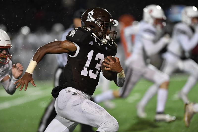 Joliet Catholic Academy's HJ Grigsby runs the ball during a game against Benet Academy Friday Oct. 14, 2022 at Joliet Memorial Stadium