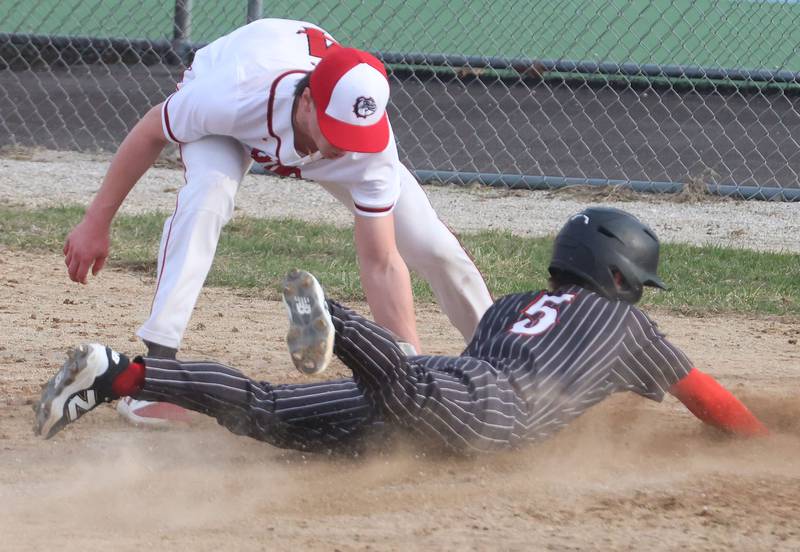 Streator's Maddan McCloskey tags out Hall's Greyson Bickett while sliding into home on Thursday, March 19, 2026 at Streator High School.