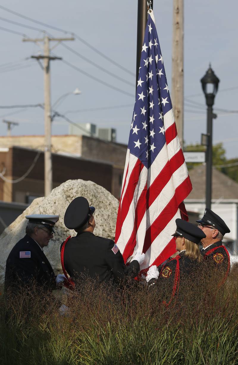 Firefighter rail the flag is raised to half mast during a September 11 Remembrance Ceremony on Sept. 11, 2025, at Veterans Park in McHenry.