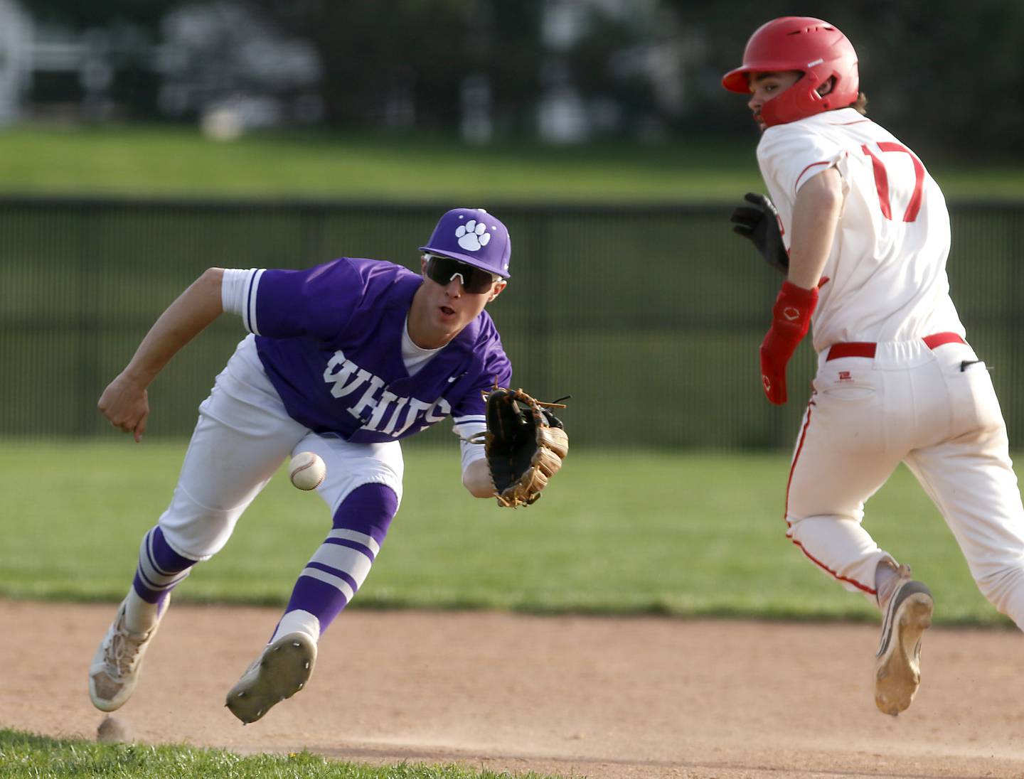 Hampshire's Cole Harkin fields a ground ball as Huntley's Dylan Visvadra runs to second during a Fox Valley Conference baseball game on Monday, April 28, 2025, at Huntley High School.
