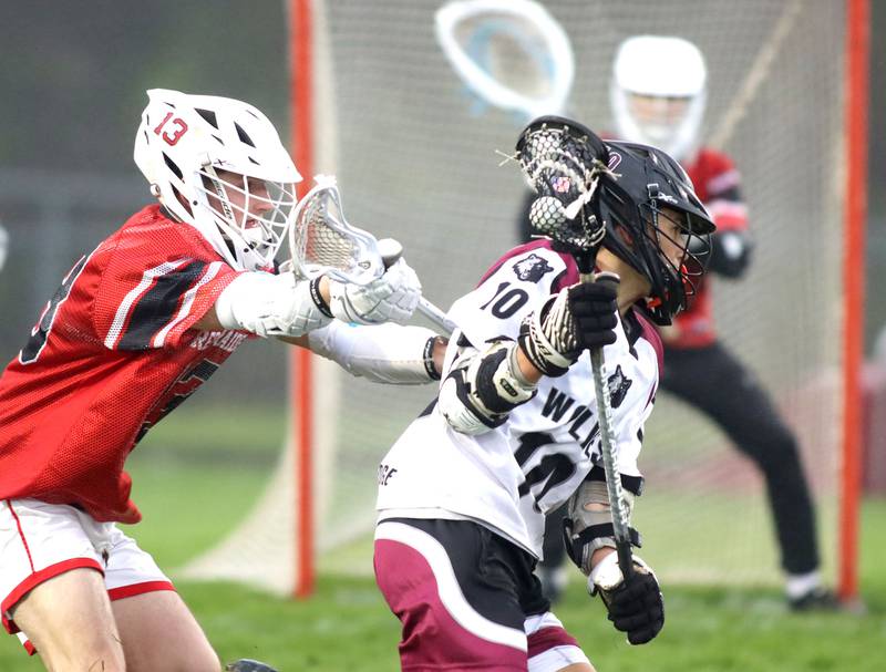 Huntley’s Dominick Goodwin, left, pursues Prairie Ridge’s Josh Marineau in varsity boys lacrosse at Prairie Ridge  High School in Crystal Lake on Thursday, May 1, 2025.