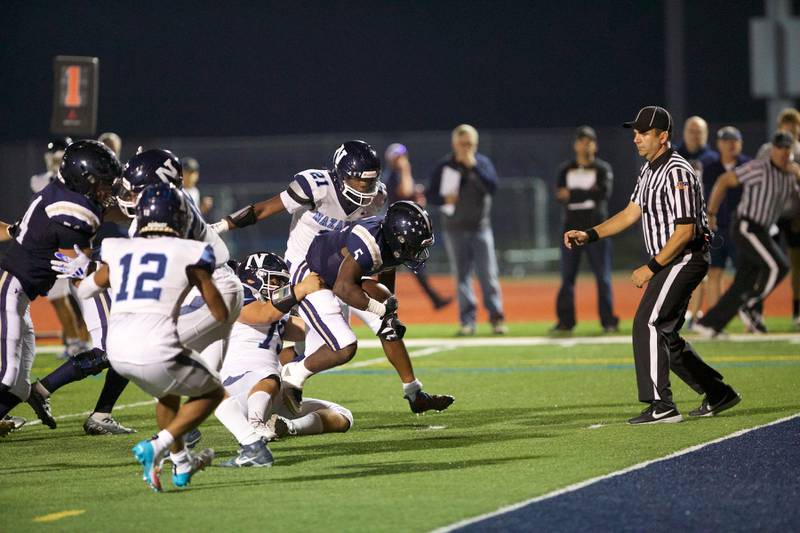 IC Catholic's Arron Harvey is tackled by Nazareth's Trenton Walker on Friday, Sept.15,2023 in Elmhurst.
