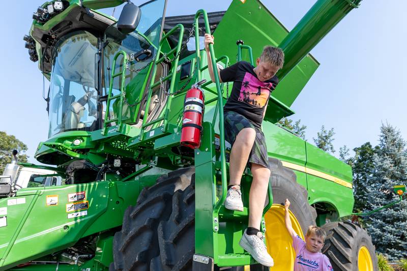 Bentley Stratton climbs down farm machine on Saturday, August 9, 2025 at the annual Wenona Days on Chestnut Street in Wenona.