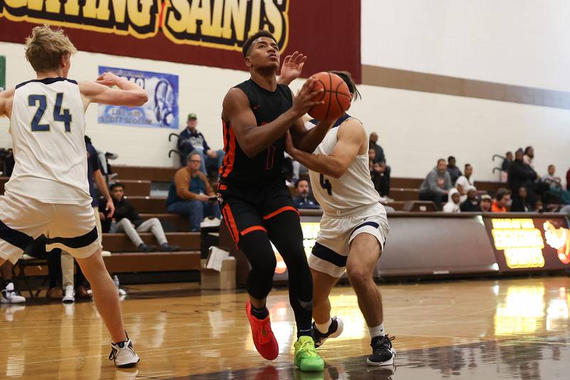 Romeoville’s Mickeis Johnson drives to the basket against Lemont in the WJOL Thanksgiving Classic Championship in Joliet on Saturday.