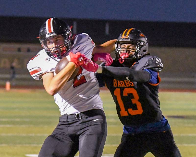 DeKalb's Davon Grant (13) pushes Lincoln-Way Central's Luke Tingley (2) out of bounds during the first quarter on Friday Sept. 20, 2024, while playing at DeKalb High School.