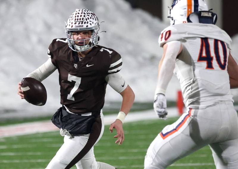 Mount Carmel's Emmett Dowling tries to get outside of Oswego's Conor Tully Wednesday, Dec. 3, 2025, during their IHSA Class 8A state chamionship game in Huskie Stadium at Northern Illinois University in DeKalb.