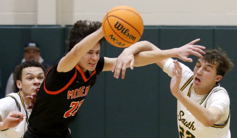 Crystal Lake South's Cooper Buelna (left)  and Anthony Santarelli (right) trie sot steal the ball from McHenry's Marko Stojich during a Fox Valley Conference basketball game on Friday, Jan. 31, 2025, at Crystal Lake South High School.