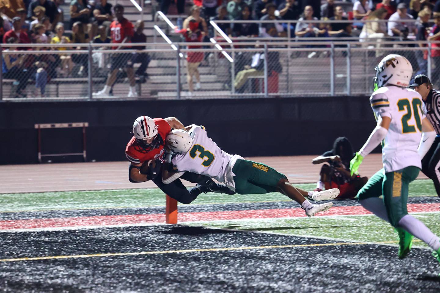 Bradley-Bourbonnais' Calvin Kohl dives into the end zone for a touchdown as Waubonsie Valley's Josiah Griffin attempts to push him out of bounds during the Boilermakers' 35-6 victory over Waubonsie Valley Friday, Sept. 12, 2025.