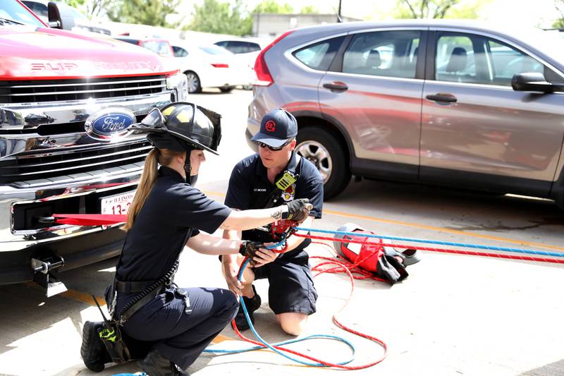 Geneva Fire Department Recruit Kelly Hunecke (left) and Lt. Rob Moore assist in a rappelling training exercise at the Third Street Commuter Parking Deck on Tuesday, May 13, 2025 in Geneva.