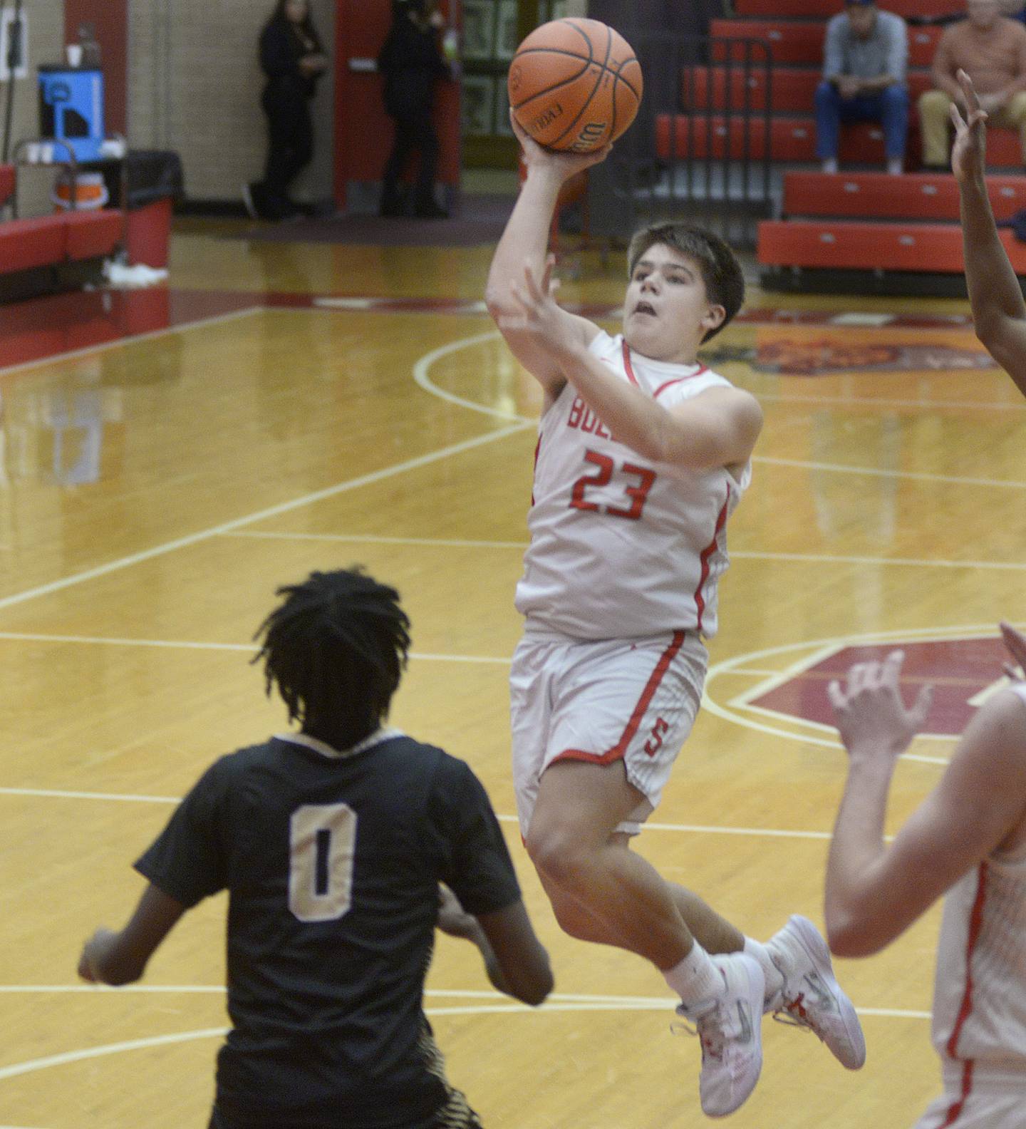 Streator’s Logan Aukland drives to the basket for a shot over Oak Forest’s Je’Sean Shannon during the 1st period Friday during the Dean Riley Shootin’ The Rock Thanksgiving Tournament at Ottawa.