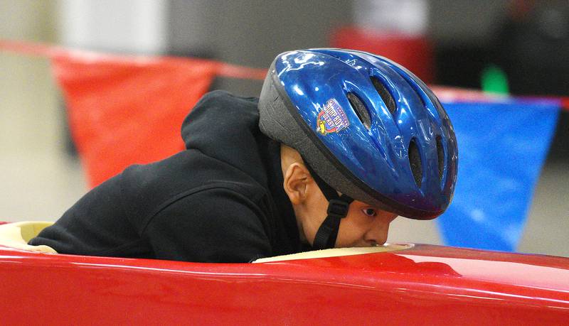 Anthony Valencia, 11, keeps his head down during soap box derby races Sunday in Batavia.