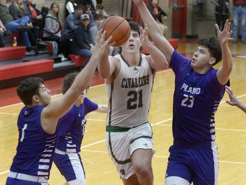 La Salle Peru’s Josh Senica goes in for a layup as Plano’s Armando Martinez and Isaiah Martinez attempt to block during the 4th period Friday during the Dean Riley Shootin’ The Rock Thanksgiving Tournament at Ottawa.