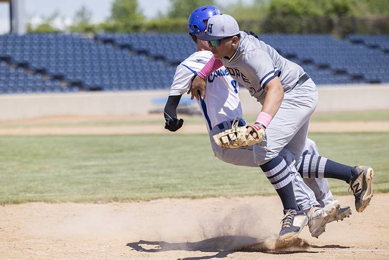 Newman’s Joe Oswalt and Chicago Hope’s Davian Villalobos collide at first base Monday, May 29, 2023.