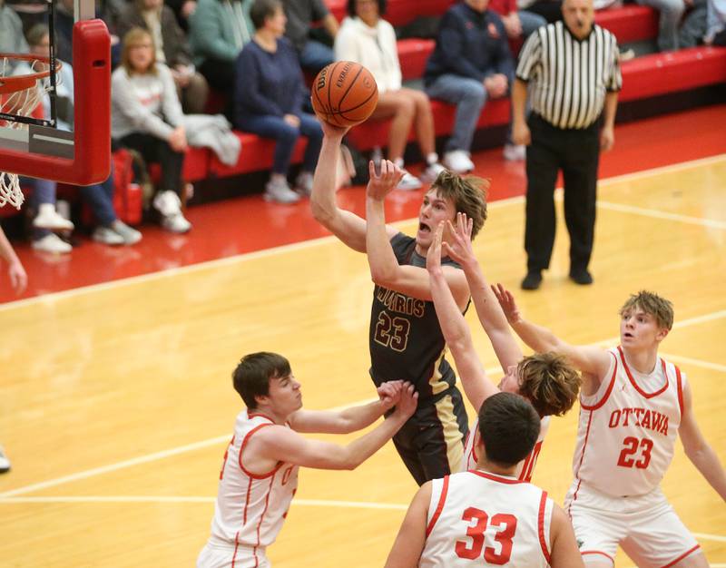 Morris's Jack Wheeler eyes the hoop against Ottawa defenders on Wednesday, Jan. 3, 2024 at Kingman Gym.