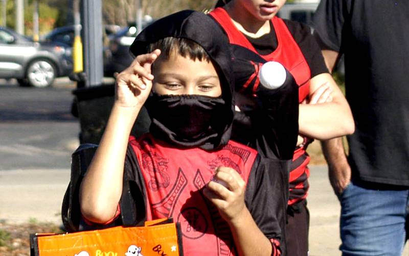 Levi Smith tosses a ball in a game at Halloween Town in downtown Sterling on Saturday, Oct. 11.