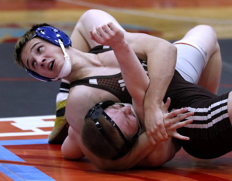 Joliet Catholic's Vince Tindal tries to pin Marian Central's Connor Cassels in their 157-pound match during a triangle wrestling meet on Saturday Jan. 11, 2025, between Marian Central, Joliet Catholic, and Mt. Carmel at Marian Central High School in Woodstock.