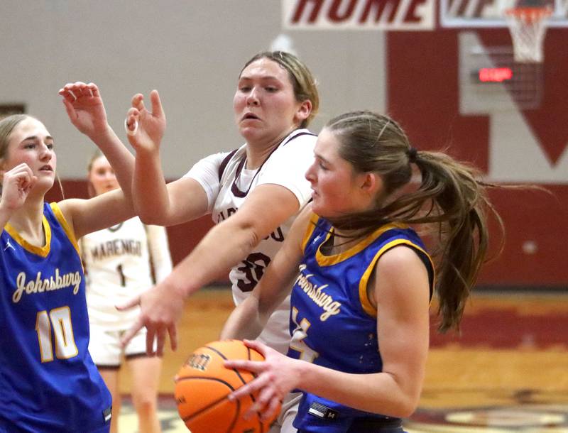 Marengo’s Macy Noe, back, battles Johnsburg’s Summer Toussaint for the ball in varsity girls basketball on Tuesday, Jan. 6, 2026 at Homer “Bill” Barry Gymnasium on the campus of Marengo High School in Marengo.