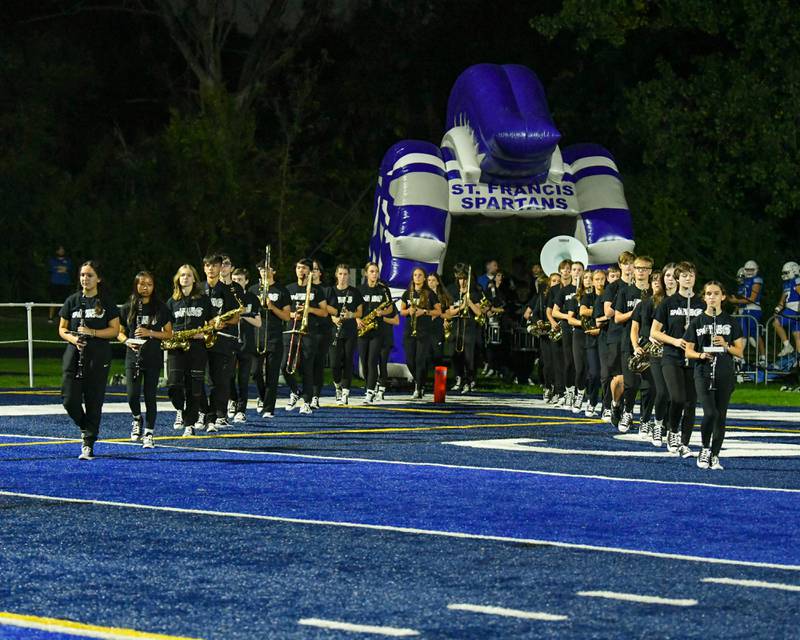 St. Francis’s marching band leads the football team onto the field on Friday Sep. 29, 2023, before the start of the game against IC Prep held at St. Francis in Wheaton.