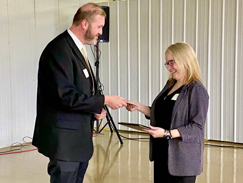The Rev. Eric Groce (left), of Gospel Life Bible Church, presents Tynisha Clegg, executive director of Family Service Agency of DeKalb County, with the 2024 Excellence in Nonprofit Award on Thursday, Feb. 13, 2025, at the chamber's 68th Annual Meeting and Awards Dinner at Custom Aluminum Products, 312 Eureka St., Genoa.