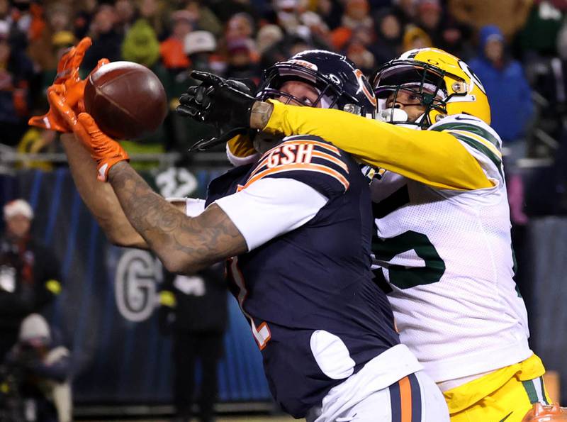 Chicago Bears wide receiver DJ Moore catches the game winning touchdown pass in front of Green Bay Packers cornerback Keisean Nixon in overtime Saturday, December 20, 2025, during their game at Soldier Field in Chicago.